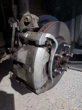 Lifted car without the wheel at the workshop Stock Photos