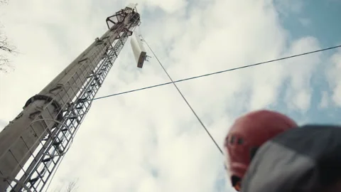 Lifting the antenna to the telecommunications tower Stock Footage 244735233