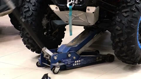 Lifting an ATV on a jack Stock Footage 173111654