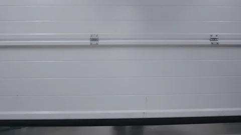 Lifting automatic gates. The person on the cart rolls out raw materials 스톡 동영상 76754304