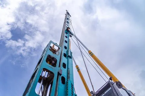 Lifting boom of a piling machine going up into the sky, bottom view Stock Photos