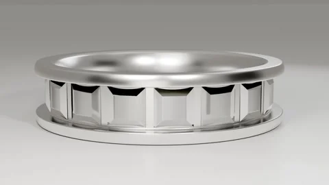 Lifting camera, rotating silver ring on base in studio revealing triangular tab Stock Footage 339194314
