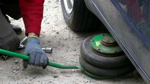 Lifting the car by the air jack system Stock Footage 91322037