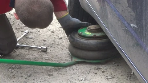 Lifting the car by the air jack system Stock Footage 104562692