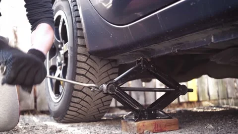 Lifting the car with a rhombic jack Stock Footage 153084766