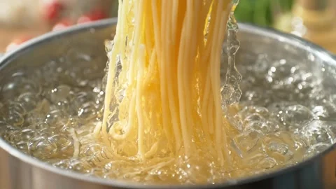 Lifting Cooked Pasta from a Pot of Boiling Water Using Spaghetti Tongs Stock Footage 278831133