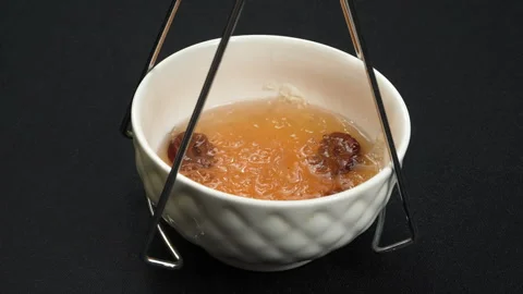 Lifting Cooked Swiftlet Bird Nest Soup Bowl Out With Gripper Stockbeeldmateriaal 339407410