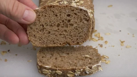 Lifting the cut slice of bread and showing its crumb 库存影片 290123868