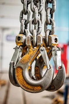 A lifting device featuring multiple heavy-duty hooks and chains, ready to han Photos