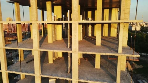 Lifting the drone parallel to a building under construction in the city center. Stock Footage 155923141