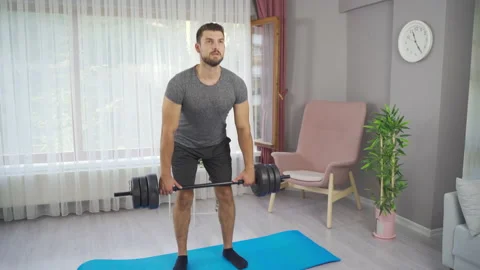 Lifting dumbbells. Exercising at home. Stock Footage 219730123