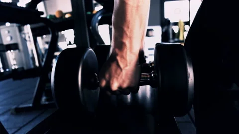 Lifting dumbbells in the gym Video stock 165870738