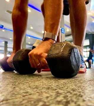 Lifting dumbbells Stock Photos