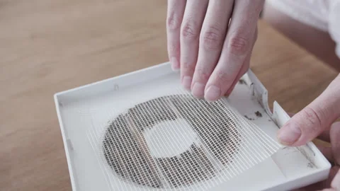 Lifting Dusty Mesh Filter Screen From Air Vent Cover Above Table Video stock 341397571