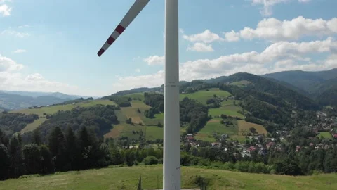 Lifting in front of a running wind turbine Stock Footage 140071333