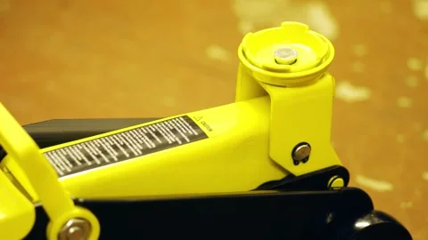 Lifting hydraulic jack using handle Stock Footage 323606021