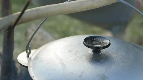 The lifting Lid over a Boiling Broth Stock Footage 98150574