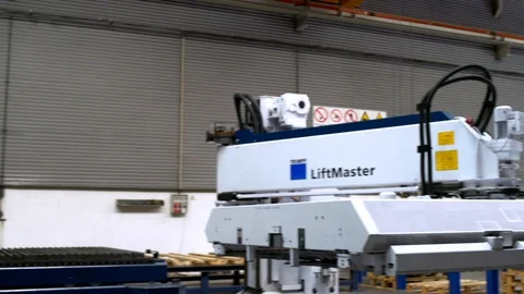 Lifting machine moving to other desk in indoor factory, Portugal Stock Footage 129067342