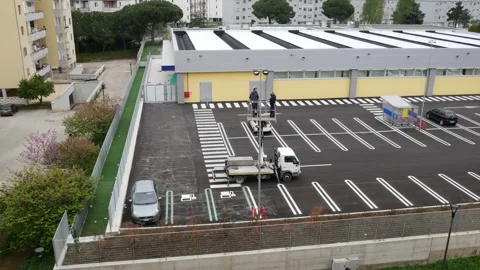 Lifting of a mobile platform with two workers controlling the lights Stock Footage 155563608