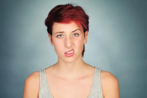 Lifting one side of her lip and eyebrow Stock Photos