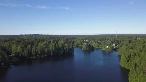 Lifting up over the lake, countryside, lots of trees Stock Footage