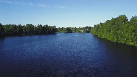 Lifting up over the lake, forest and countryside Video stock 77735206