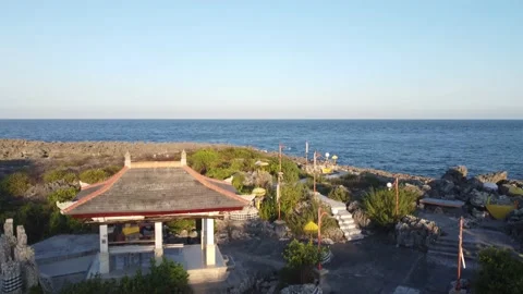 Lifting up over temple to a horizon and seaview Stock Footage 155550488