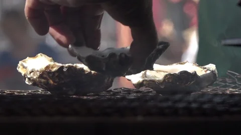 Lifting oyster off BBQ CU Stock Footage 115665162