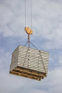 Lifting pallet with formwork elements by crane Stock Photos