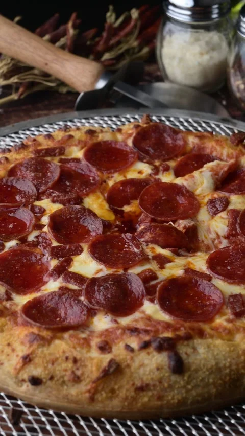 Lifting up pepperoni pizza with extra cheese Stock Footage 273636421