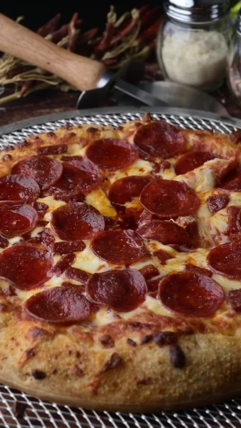 Lifting up pepperoni pizza with extra cheese Stock-Footage 273636711