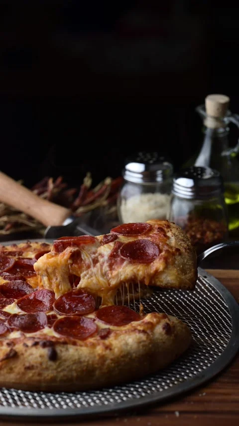 Lifting up pepperoni pizza with extra cheese Stock-Footage 273637296