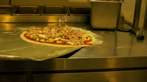 Lifting pizza dough to put in an oven with Sauce, mushroom, and beacon Stock Footage 166283319
