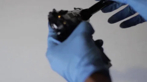 Lifting prints off of a gun Stock Footage 79381777