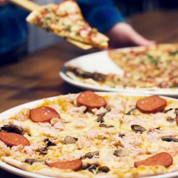 The lifting slice of hot pizza, closeup Stock Photos