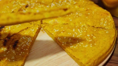 Lifting Slice of Tibetan Barley Flatbread with Sesame Topping Stock Footage 312584011