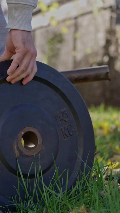 Lifting Weights Outdoors Engaging in Strength Training While Surrounded by Stock Footage 308111244