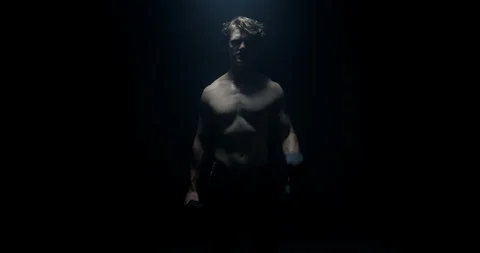 Lifting Weights Staring At Camera On Spotlight Preparing For Big Match  Stock Footage 113888482