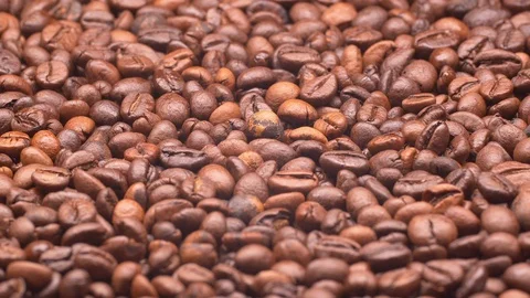 Ligh roasted coffee beans on a turntable in UHD Stock-Footage 100532961