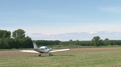 Light aircraft moving on field Stock Footage 36773226