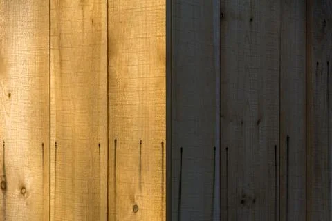 Light and Dark View of The Side of a Wood Paneled Building Stock Photos
