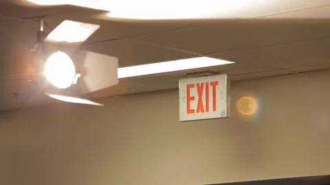 Light and Exit Sign Hanging From Ceiling Stock Footage 102574656