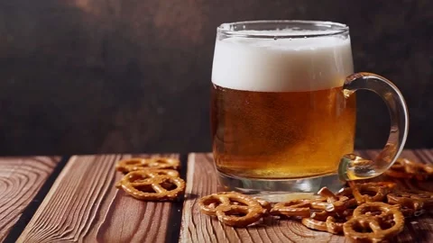 Light and refreshing cold beer is poured into a beer mug. It makes a lot of Stock Footage 135014693