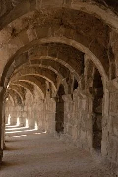 Light and shadow in ancient building with many arches in it Stock Photos