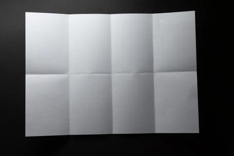 Light and shadow on creases in sheet of white paper folded into eight equal 스톡 일러스트