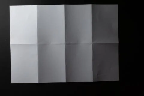 Light and shadow on creases in sheet of white paper folded into eight equal Stockillustratie