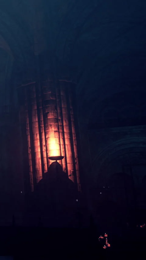 Light and shadow in a dark church with candles and stone walls Stock Footage 335692153