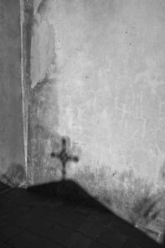 Light and Shadow on a graveyard. A jesus cross. Stock Photos