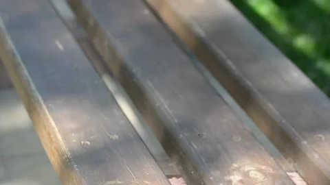 Light and shadow on the ground from a street bench Stock Footage 131496757