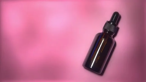 Light and shadow moving on serum bottle with pink background Stock Footage 167766144